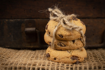 Cookies tied with a gray jute string into a bow. Cookies of sweets on a wooden kitchen table.