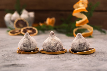 Three chocolates on the background of Christmas decorations to celebrate Christmas.