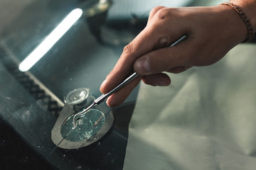 Close up Automobile glazier worker fixing and repair windscreen or windshield of a car in auto...
