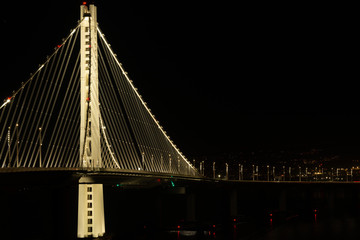 Eastside tower of the Bay Bridge at night under the lights
