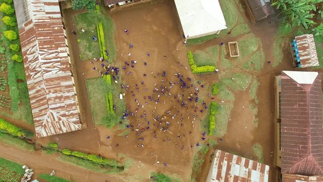 Straight down Aerial Shot of a local school and children in the mountain village of Materuni at Kilimanjaro, Tanzania