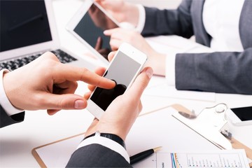 Young business couple working together with gadgets