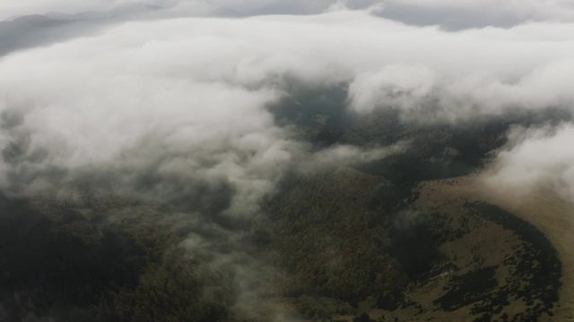 Aerial View, Flying over autumn forest mountains with beautiful clouds, Slovakia
