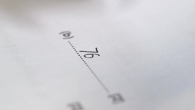 A close up of a ball point pen answering a question in a maths paper/maths exam.