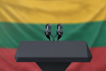 Obraz premium Podium lectern with two microphones and Lithuania flag in background