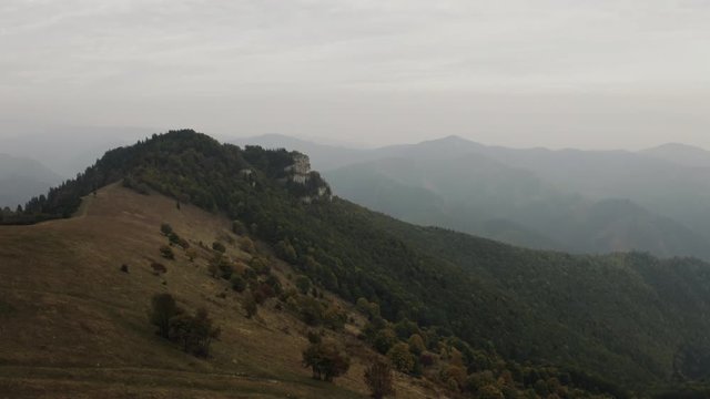 Fast flying towards rock formation over autumn trees, Aerial wide shot, Slovakia