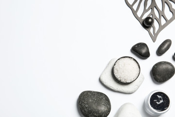 Flat lay composition with spa stones and space for text on white background