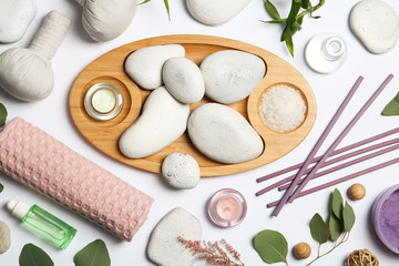 Composition with spa stones on white background, top view