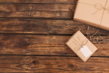 Parcels and space for text on wooden background, flat lay