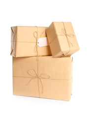 Stacked parcels wrapped in kraft paper on white background