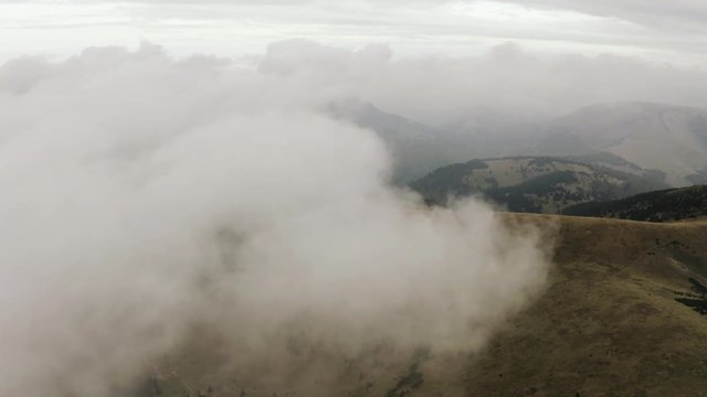 Aerial shot of Flying towards white cloud over autumn mountain, Slovakia