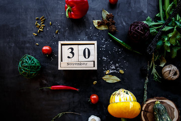 Image November 30th. Dark background with autumn things. Concept of end of autumn, last day bedfore winter