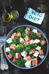 Healthy salad for keto diet. Salad with broccoli, white cheese and salmon. Keto lunch idea. A note with the inscription Keto Diet.