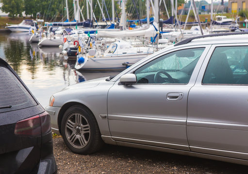 cars on the beach near the marina
