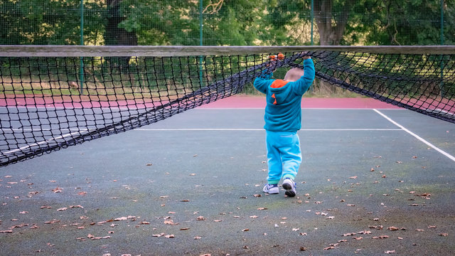 Little boy walking under the net