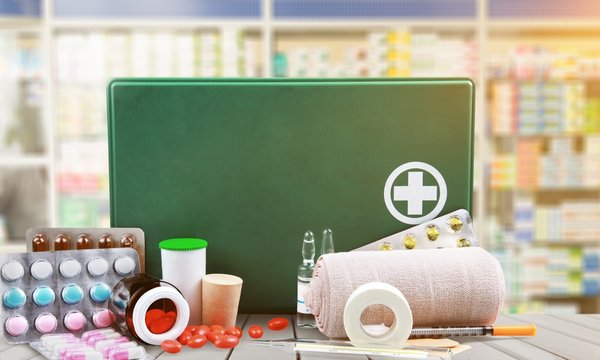 First aid kit  with medical supplies on light background