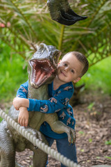 Boy hugging reptor dinosaur figure