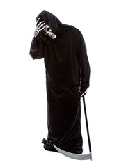 Halloween costume of a skeleton grim reaper wearing a black robe on a white background looking...