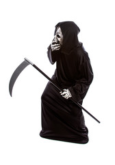 Halloween costume of a skeleton grim reaper wearing a black robe on a white background looking...