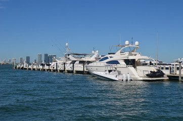 Fototapeta na wymiar High-end white motor yacht moored at a marina in the south beach section of Miami Beach,Florida
