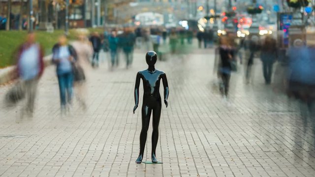 The dummy standing on the street with people. time lapse