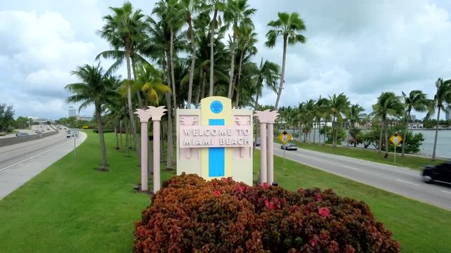 Shot coming out from Welcome To Miami Beach sign in Miami