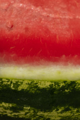 background. delicious red watermelon with black seeds and green skin
