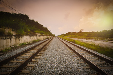 Fototapeta na wymiar Railroad tracks in the setting sun