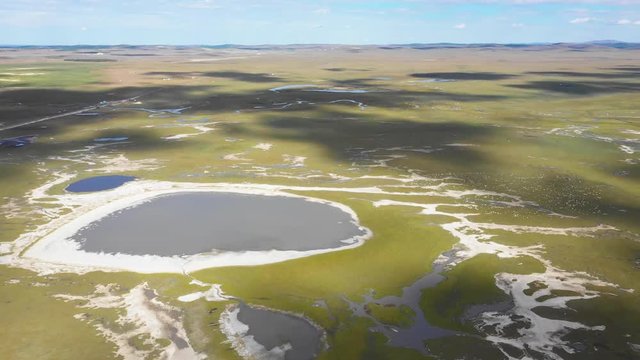 Cloud shadow moving on meadow and lake surface, Inner Mongolia, China.