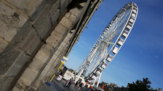Places of world war one in Belgium: Ypres today, tourism, traffic,shops, big wheel, people walking in the city