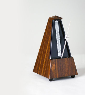 Metronome in action, closeup, isolated and on a plain background