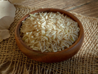 Bowl of long grain organic brown rice in low light.