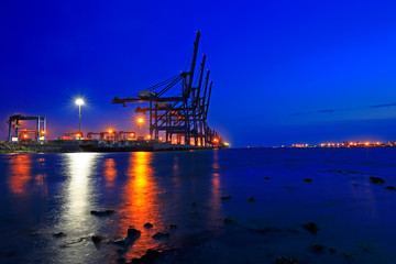 Fototapeta na wymiar Port crane unloading container ships