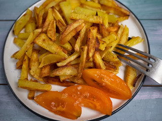 breakfast of fried potatoes with fresh popidoms