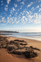 Clouds over  the rocks on Cape Woolamai beach, with the Pinnacles rock formation visible in the background