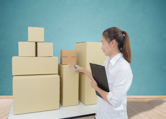 Young business woman, entrepreneur holding a clipboard, check the product
