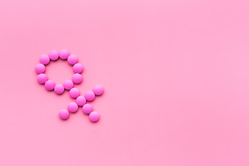 Female diseases. Female gender icon symbol made of pills on pink background top view space for text