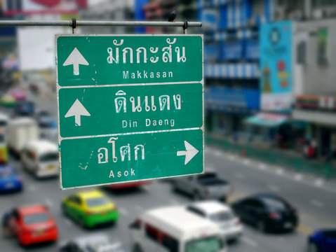 Street Directional Labels with Thai and English Texts and Arrows to Other Places in Bangkok