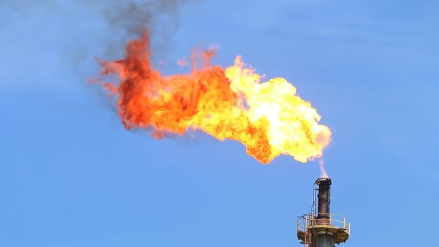 Fire on flare stack at oil and gas central processing platform release over pressure from process. Petroleum refinery plant