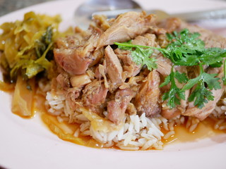 Close up of stewed pork leg with pickled cabbage on rice (Kao Ka Moo)