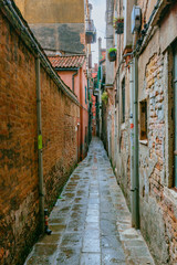 Fototapeta na wymiar Venetian houses and alley in Venice, Italy