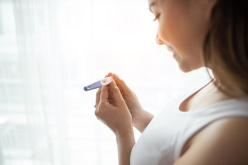 Young woman hand holding pregnancy test © Johnstocker