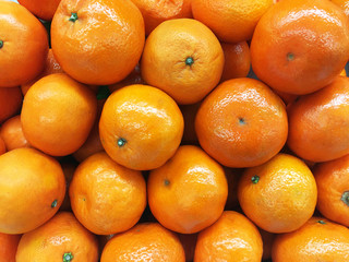 Healthy fruits, orange fruits background many orange fruits - orange fruit background in a supermarket super store