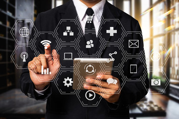 Digital marketing media  in virtual icon globe shape business open his hand, working touch screen computer, smartphone and tablet front view in morning light