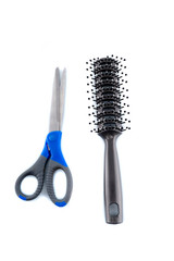 Scissors and comb isolated on white background