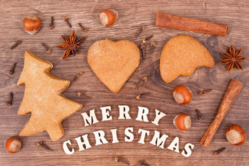 Gingerbreads, inscription Merry Christmas and ingredients for baking