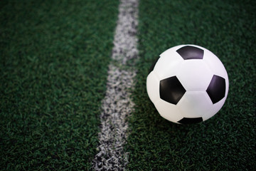 soccer ball on the white line at stadium