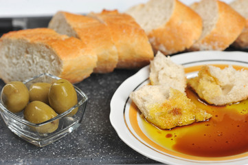 pieces of baguette dipped in olive oil with balsamic vinegar