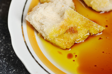 pieces of baguette dipped in olive oil with balsamic vinegar