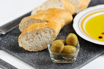 olives, baguette and olive oil